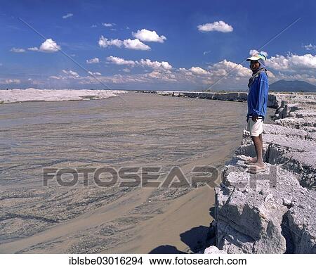 Picture - "Boy standing on the bank of a mudstream, Mt Pinatubo, lahar fields, lahar, pyroclastic flow, Zambales, Pampanga, Luzon, Philippines, Asia". Fotosearch