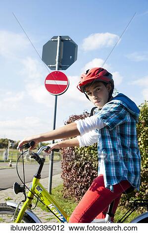 Stock Image - Boy wearing a bike helmet at a traffic awareness course. Fotosearch