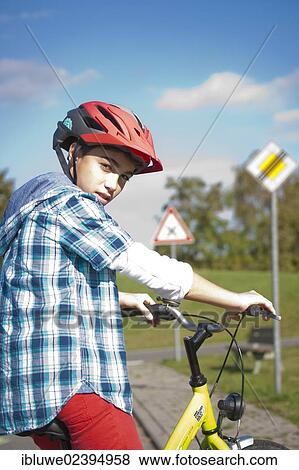 Boy wearing a bike helmet at a traffic awareness course View Large Photo Image Stock Photo - Boy wearing a bike helmet at a traffic awareness course. Fotosearch