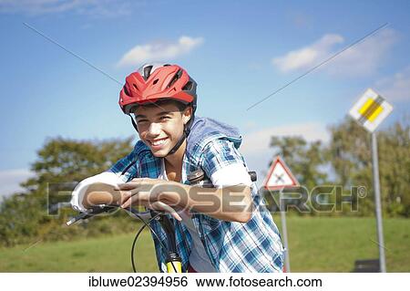 Boy wearing a bike helmet at a traffic awareness course View Large Photo Image Stock Photograph - Boy wearing a bike helmet at a traffic awareness course. Fotosearch