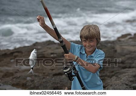 Stock Photography - "Boy with a caught fish, Sant Antoni, Ibiza, Pitiusic Islands or Pine Islands, Balearic Islands, Spain, Europe". Fotosearch