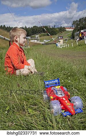 "Boy with a toy racing car, Bergring Teterow motorcycle race track, Mecklenburgische Schweiz region, Mecklenburg-Western Pomerania, Germany, Europe" View Large Photo Image Stock Image - "Boy with a toy racing car, Bergring Teterow motorcycle race track, Mecklenburgische Schweiz region, Mecklenburg-Western Pomerania, Germany, Europe". Fotosearch