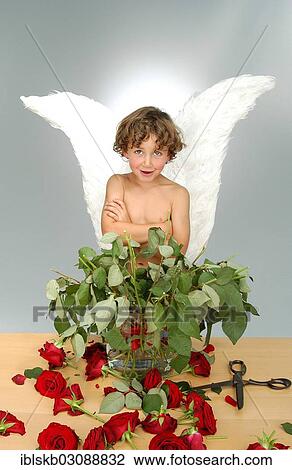 "Boy with angel wings, after cutting the heads off a bouquet of roses with a large pair of scissors" View Large Photo Image Stock Image - "Boy with angel wings, after cutting the heads off a bouquet of roses with a large pair of scissors". Fotosearch