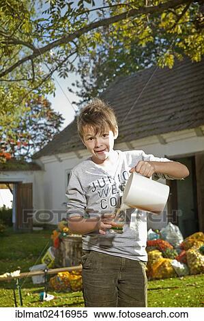 Stock Photography - Boy with freshly squeezed apple juice. Fotosearch