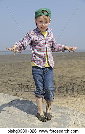 "Boy with his hands and feet full of mud in the mudflats of the Wadden Sea, Duhnen, Cuxhaven, Lower Saxony, Germany, Europe" View Large Photo Image Stock Photograph - "Boy with his hands and feet full of mud in the mudflats of the Wadden Sea, Duhnen, Cuxhaven, Lower Saxony, Germany, Europe". Fotosearch