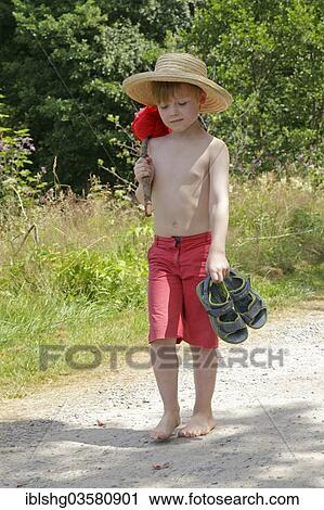 "Boy with stick and hat, sandals in hand, Germany, Europe" View Large Photo Image Stock Image - "Boy with stick and hat, sandals in hand, Germany, Europe". Fotosearch