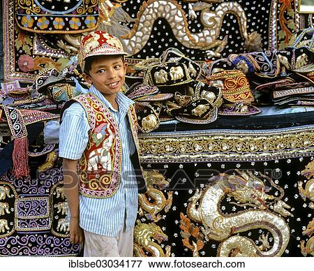 "Boy with traditional textile art, tapestries and bags at a market, Tachilek, Shan State, Myanmar, Burma, Asia" View Large Photo Image Stock Photo - "Boy with traditional textile art, tapestries and bags at a market, Tachilek, Shan State, Myanmar, Burma, Asia". Fotosearch