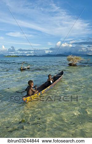 "Boys in a canoe in the Marovo Lagoon, Marovo Lagoon, Western Province, Solomon Islands, Oceania" View Large Photo Image Picture - "Boys in a canoe in the Marovo Lagoon, Marovo Lagoon, Western Province, Solomon Islands, Oceania". Fotosearch