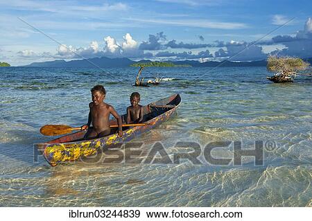 "Boys in a canoe in the Marovo Lagoon, Marovo Lagoon, Western Province, Solomon Islands, Oceania" View Large Photo Image Stock Photo - "Boys in a canoe in the Marovo Lagoon, Marovo Lagoon, Western Province, Solomon Islands, Oceania". Fotosearch