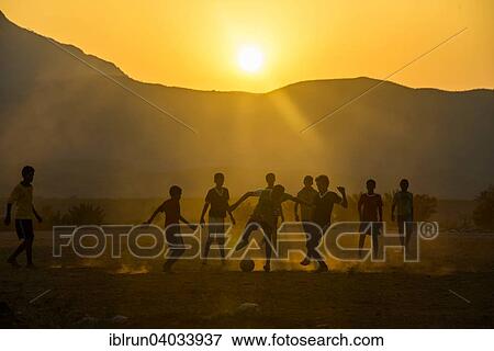 Stock Photo - "Boys playing soccer, Socotra, Yemen, Asia". Fotosearch