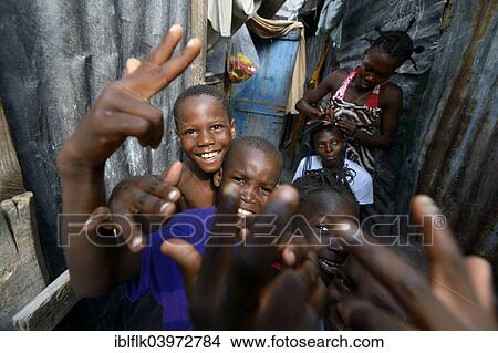 Picture - "Boys posing and laughing, camp for earthquake refugees camp Icare, Fort National, Port-au-Prince, Haiti, North America". Fotosearch