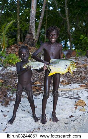Stock Photo - "Boys proudly showing the fish they caught, Marovo Lagoon, Western Province, Solomon Islands, Oceania". Fotosearch