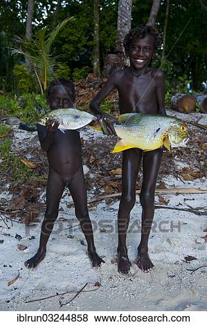"Boys proudly showing the fish they caught, Marovo Lagoon, Western Province, Solomon Islands, Oceania" View Large Photo Image Stock Photo - "Boys proudly showing the fish they caught, Marovo Lagoon, Western Province, Solomon Islands, Oceania". Fotosearch