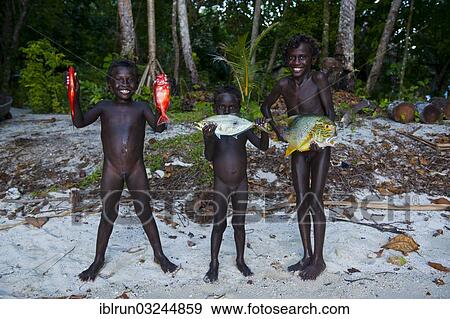 "Boys proudly showing the fish they caught, Marovo Lagoon, Western Province, Solomon Islands, Oceania" View Large Photo Image Stock Photo - "Boys proudly showing the fish they caught, Marovo Lagoon, Western Province, Solomon Islands, Oceania". Fotosearch
