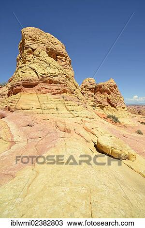 Stock Image - "Brain Rocks of the Coyote Buttes South CBS, Cottonwood Teepees, eroded Navajo sandstone rock formations with Liesegang bands or Liesegang rings, Pareah Paria Plateau, Vermilion Cliffs National Monument, Arizona, Utah, Southwestern USA". Fotosearch