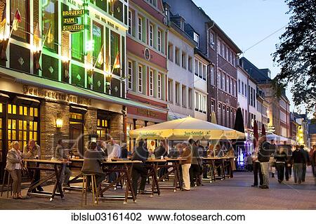 Stock Image - "Brauhaus Zum Schluessel, inn, Bolkerstrasse street, old town at dusk, Dusseldorf, Rhineland, North Rhine-Westphalia, Germany, Europe". Fotosearch