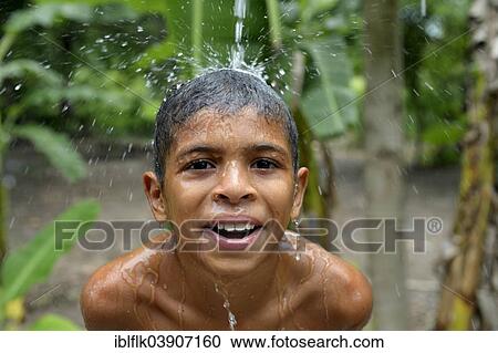 "Brazilian boy holding his head in a stream of water and laughing, social project for street children, Maranguape, Ceara, Brazil, South America" View Large Photo Image Stock Image - "Brazilian boy holding his head in a stream of water and laughing, social project for street children, Maranguape, Ceara, Brazil, South America". Fotosearch
