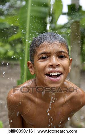 "Brazilian boy holding his head in a stream of water and laughing, social project for street children, Maranguape, Ceara, Brazil, South America" View Large Photo Image Stock Image - "Brazilian boy holding his head in a stream of water and laughing, social project for street children, Maranguape, Ceara, Brazil, South America". Fotosearch