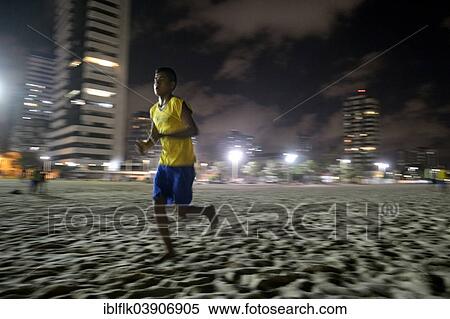 "Brazilian teenager training at night on the beach for the Street Children World Cup 2014, Praia de Iracema, Fortaleza, Ceara, Brazil, South America" View Large Photo Image Stock Photography - "Brazilian teenager training at night on the beach for the Street Children World Cup 2014, Praia de Iracema, Fortaleza, Ceara, Brazil, South America". Fotosearch
