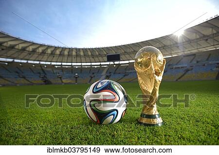 "Brazuca by Adidas, official match ball of the 2014 FIFA World Cup in Brazil, next to the World Cup trophy at the Estadio do Maracana, Rio de Janeiro, Brazil, South America" View Large Photo Image Stock Photo - "Brazuca by Adidas, official match ball of the 2014 FIFA World Cup in Brazil, next to the World Cup trophy at the Estadio do Maracana, Rio de Janeiro, Brazil, South America". Fotosearch