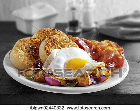 "Breakfast with crumpets, fried egg, bacon and sauteed potatoes" View Large Photo Image Stock Image - "Breakfast with crumpets, fried egg, bacon and sauteed potatoes". Fotosearch
