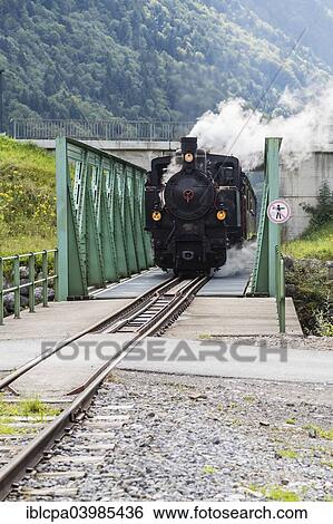 Stock Photograph - "Bregenz Forest Railway with steam locomotive crossing steel bridge, Bregenz Forest, Vorarlberg, Austria, Europe". Fotosearch