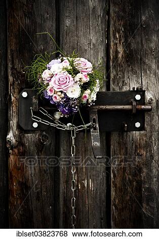 Bridal bouquet in an old door lock View Large Photo Image Stock Photo - Bridal bouquet in an old door lock. Fotosearch
