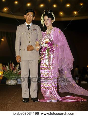 "Bridal couple, groom wearing a military uniform, bride wearing traditional costume, wedding, Rangun, Yangon Region, Myanmar, Burma, Asia" View Large Photo Image Stock Photograph - "Bridal couple, groom wearing a military uniform, bride wearing traditional costume, wedding, Rangun, Yangon Region, Myanmar, Burma, Asia". Fotosearch
