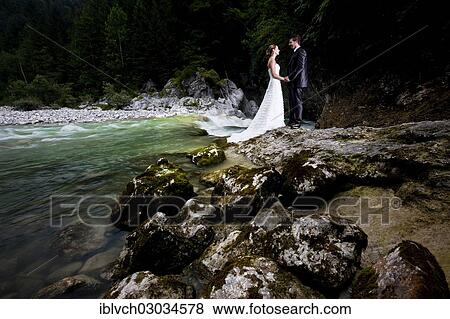 "Bridal couple standing beside a torrent and looking lovingly at one another, Brandenberger Ache, Kramsach, Kufstein District, North Tirol, Tirol, Austria, Europe" View Large Photo Image Stock Photo - "Bridal couple standing beside a torrent and looking lovingly at one another, Brandenberger Ache, Kramsach, Kufstein District, North Tirol, Tirol, Austria, Europe". Fotosearch