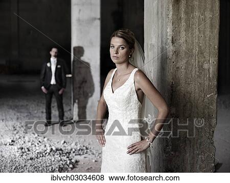 Stock Photo - "Bridal couple standing in an old industrial hall, Austria, Europe". Fotosearch