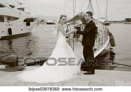 Bride and groom boarding a yacht in a marina View Large Photo Image Stock Photo - Bride and groom boarding a yacht in a marina. Fotosearch