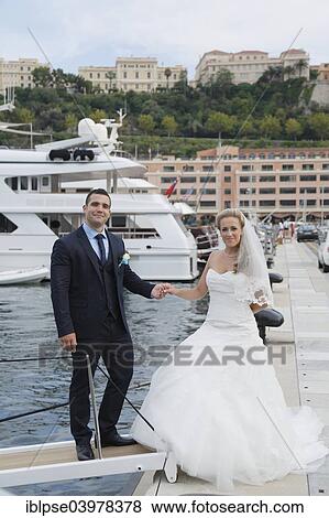 Bride and groom boarding a yacht in a marina View Large Photo Image Stock Photo - Bride and groom boarding a yacht in a marina. Fotosearch