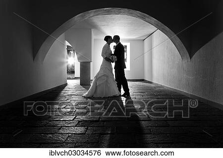 "Bride and groom kissing under the arch of an old vault, Rattenberg, Tyrol, Austria, Europe" View Large Photo Image Stock Photograph - "Bride and groom kissing under the arch of an old vault, Rattenberg, Tyrol, Austria, Europe". Fotosearch