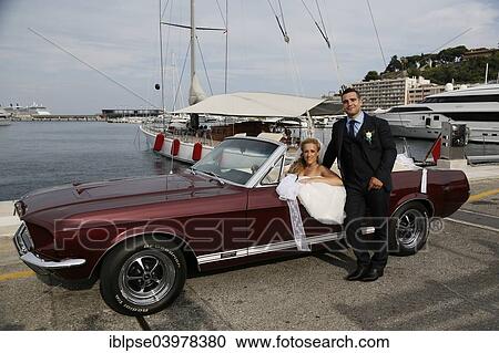 Bride and groom posing with an open Ford Mustang convertible car at a harbour View Large Photo Image Stock Image - Bride and groom posing with an open Ford Mustang convertible car at a harbour. Fotosearch