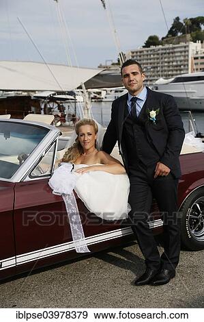 Bride and groom posing with an open Ford Mustang convertible car at a harbour View Large Photo Image Stock Photo - Bride and groom posing with an open Ford Mustang convertible car at a harbour. Fotosearch