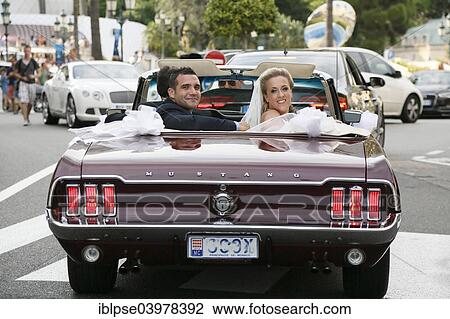 "Bride and groom riding in an open Ford Mustang convertible car through the city, Monaco, Europe" View Large Photo Image Stock Image - "Bride and groom riding in an open Ford Mustang convertible car through the city, Monaco, Europe". Fotosearch