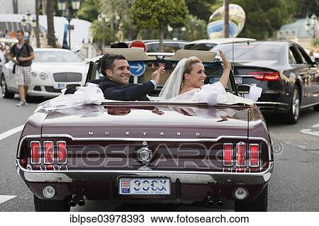 "Bride and groom riding in an open Ford Mustang convertible car through the city, Monaco, Europe" View Large Photo Image Stock Image - "Bride and groom riding in an open Ford Mustang convertible car through the city, Monaco, Europe". Fotosearch