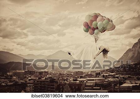 "Bride floating on balloons over Innsbruck, Tyrol, Austria, Europe" View Large Photo Image Picture - "Bride floating on balloons over Innsbruck, Tyrol, Austria, Europe". Fotosearch