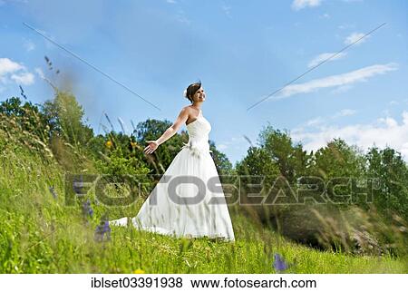 "Bride standing on a meadow in Tyrol, Arzl, Innsbruck, Tyrol, Austria, Europe" View Large Photo Image Stock Photo - "Bride standing on a meadow in Tyrol, Arzl, Innsbruck, Tyrol, Austria, Europe". Fotosearch