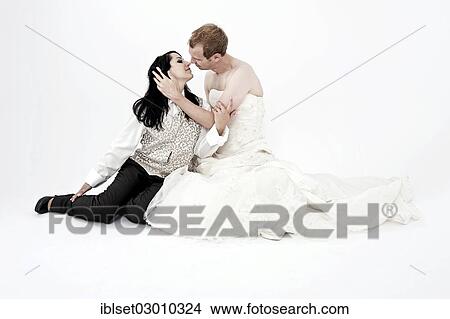 "Bride wearing a suit kissing a groom wearing a wedding dress, exchange of wedding clothing, Austria, Europe" View Large Photo Image Picture - "Bride wearing a suit kissing a groom wearing a wedding dress, exchange of wedding clothing, Austria, Europe". Fotosearch