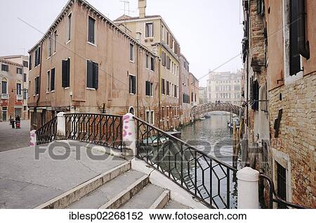 Stock Image - "Bridge, houses along a canal, Venice, Venezia, Veneto, Italy, Europe". Fotosearch