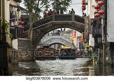 Stock Photograph - "Bridge over a waterway with boats, Suzhou, China, Asia". Fotosearch