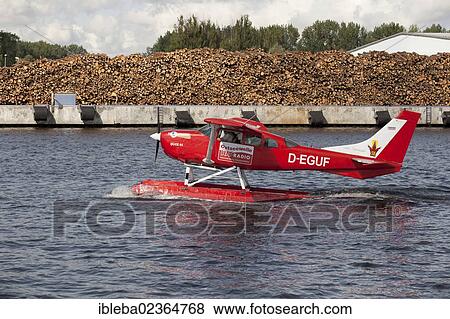 "Bright red seaplane, Duck 01, a Cessna 206, in the old fishing port of Rostock, Mecklenburg-Western Pomerania, Germany, Europe" View Large Photo Image Stock Photo - "Bright red seaplane, Duck 01, a Cessna 206, in the old fishing port of Rostock, Mecklenburg-Western Pomerania, Germany, Europe". Fotosearch