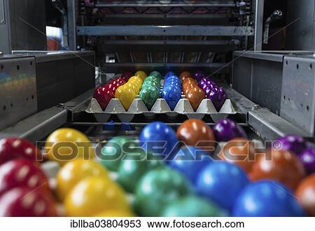 "Brightly coloured Easter eggs on a conveyor belt, Beham egg dyeing company, Thannhausen, Bayern, Germany, Europe" View Large Photo Image Stock Image - "Brightly coloured Easter eggs on a conveyor belt, Beham egg dyeing company, Thannhausen, Bayern, Germany, Europe". Fotosearch