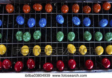 "Brightly coloured Easter eggs on a conveyor belt, Beham egg dyeing company, Thannhausen, Bayern, Germany, Europe" View Large Photo Image Stock Photo - "Brightly coloured Easter eggs on a conveyor belt, Beham egg dyeing company, Thannhausen, Bayern, Germany, Europe". Fotosearch
