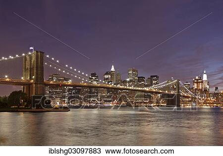 Stock Image - "Brooklyn Bridge in front of the Manhattan skyline in the evening, Manhattan, New York City, New York, United States, North America". Fotosearch