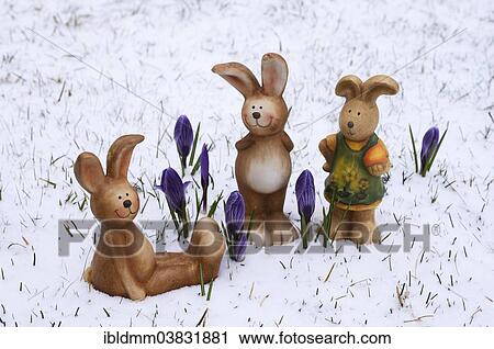 "Brown ceramic Easter Bunnies, blue crocuses, snow" View Large Photo Image Stock Image - "Brown ceramic Easter Bunnies, blue crocuses, snow". Fotosearch