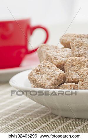 Brown sugar cubes and a red coffee cup View Large Photo Image Stock Photograph - Brown sugar cubes and a red coffee cup. Fotosearch