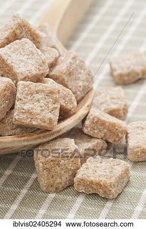 Brown sugar cubes on a wooden spoon View Large Photo Image Picture - Brown sugar cubes on a wooden spoon. Fotosearch