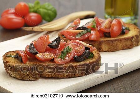 Bruschetta with tomatoes and black olives View Large Photo Image Stock Image - Bruschetta with tomatoes and black olives. Fotosearch